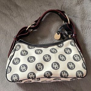 Gently used authentic Dooney & Bourke handbag. Black & white with red threading